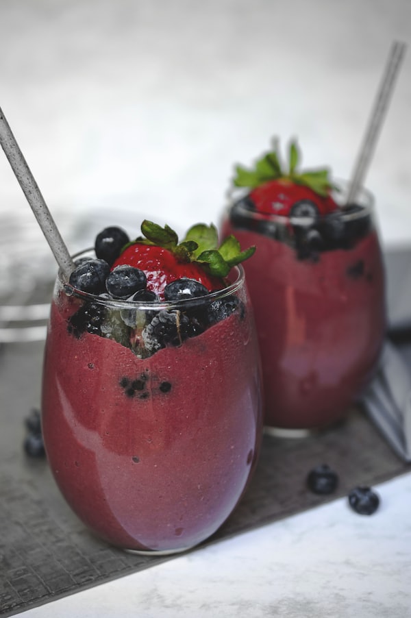 Green smoothie with fresh fruit garnish
